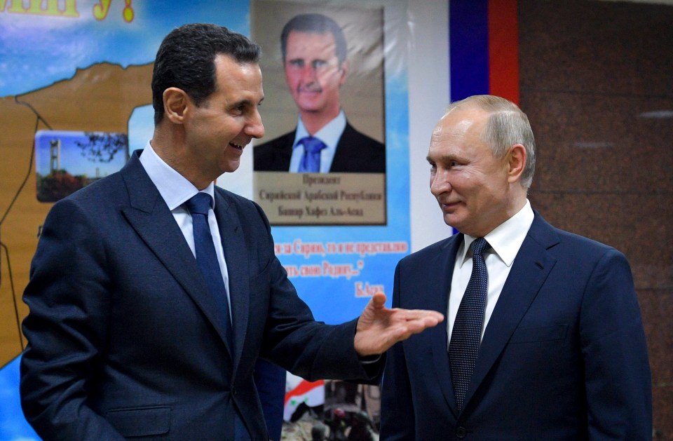 Syrian President Bashar Assad, left, gestures while speaking to Russian President Putin