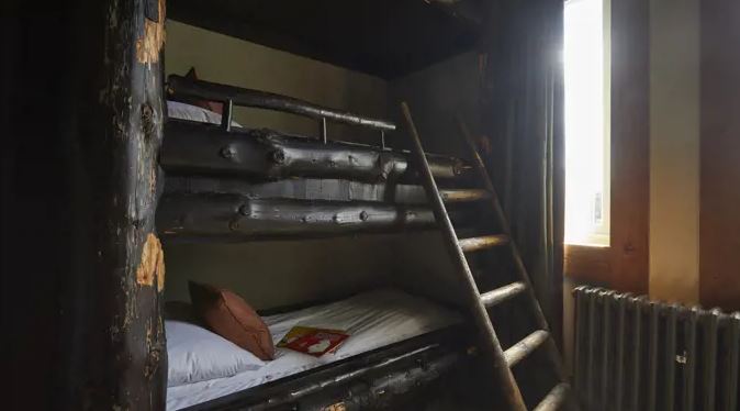 Wooden bunk bed in a hotel room.