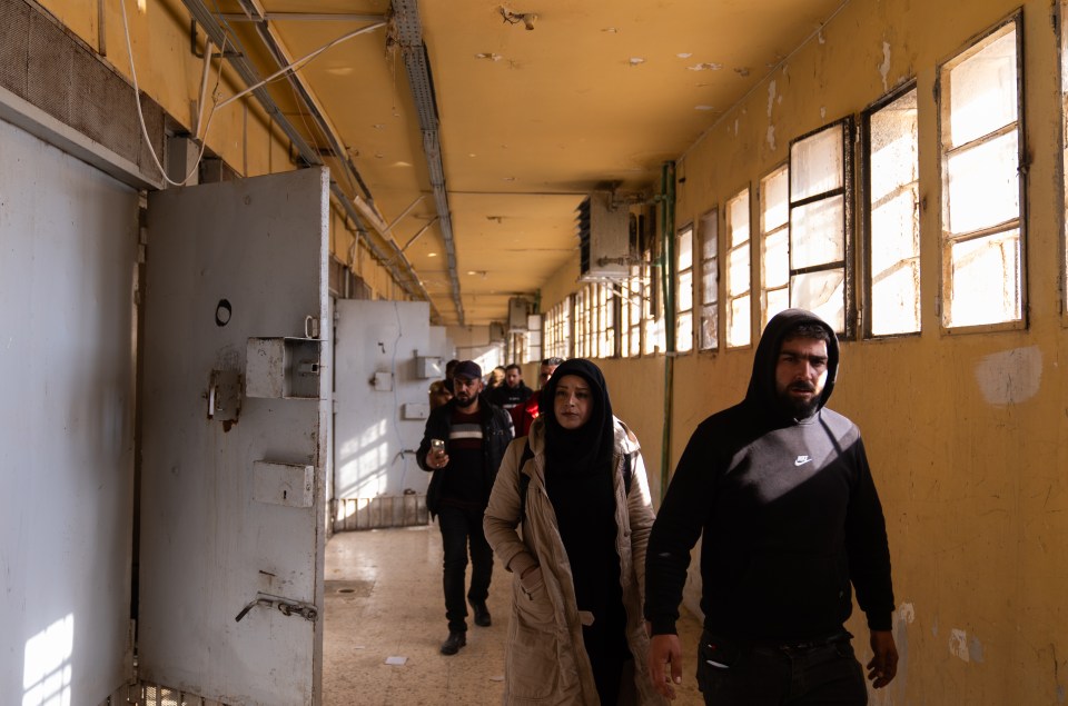 People walking through the prison after it was liberated