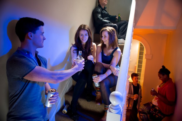 Teenagers drinking alcohol at a house party.