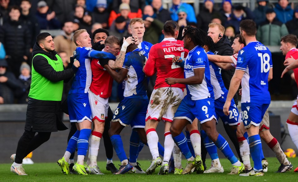 Players in a soccer match shoving each other after the final whistle.