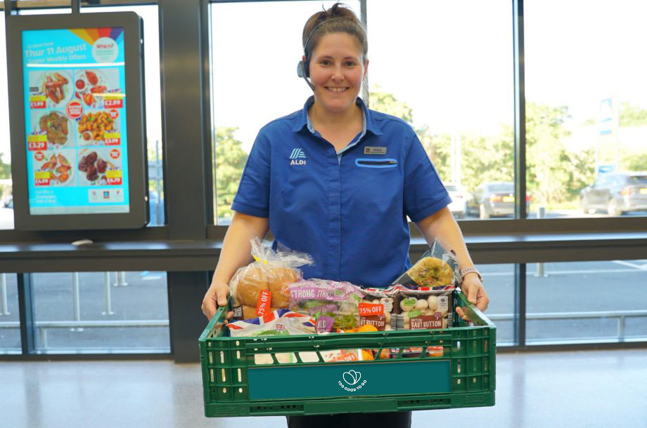 ALDI employee carrying a crate of food for Too Good To Go.