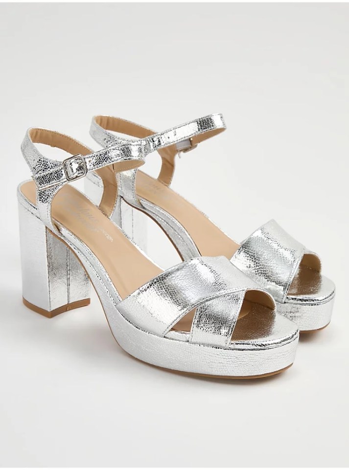 Silver platform sandals with ankle straps.