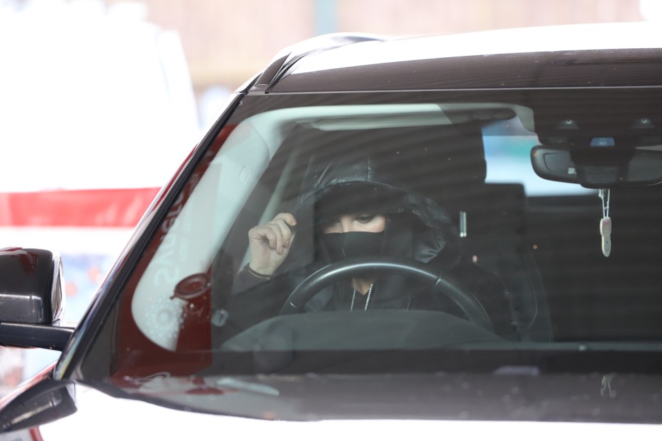 The N-Dubz star wore a hooded black puffer jacket and face mask