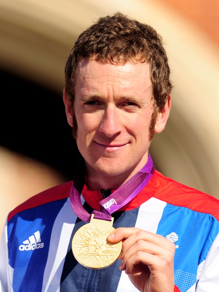 Bradley Wiggins holding his gold medal from the London Olympic Games.