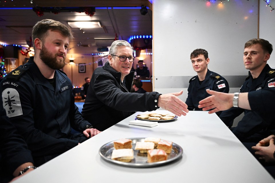 UK Prime Minister Keir Starmer shaking hands with Royal Navy crew members.