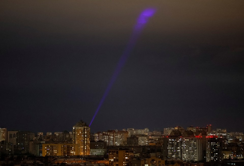 Searchlight scanning the sky over Kyiv during a Russian drone strike.