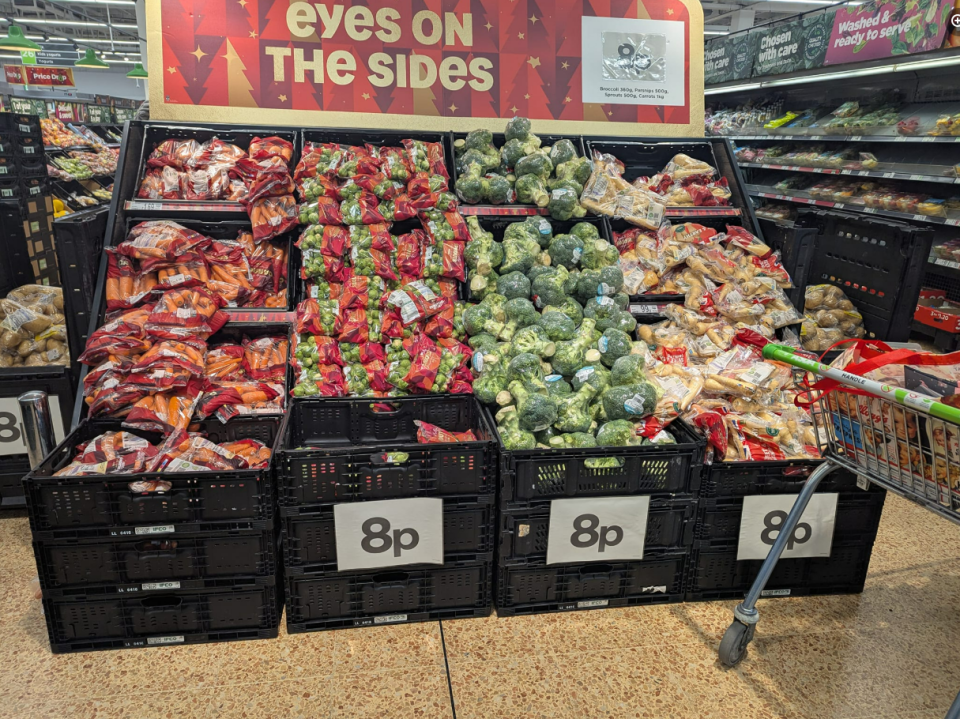 Supermarket display of carrots, brussels sprouts, broccoli, and parsnips, all priced at 8p.