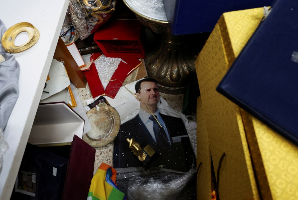 Scattered personal belongings and a large photo of Bashar al-Assad amidst the debris in the Syrian Presidential Palace.