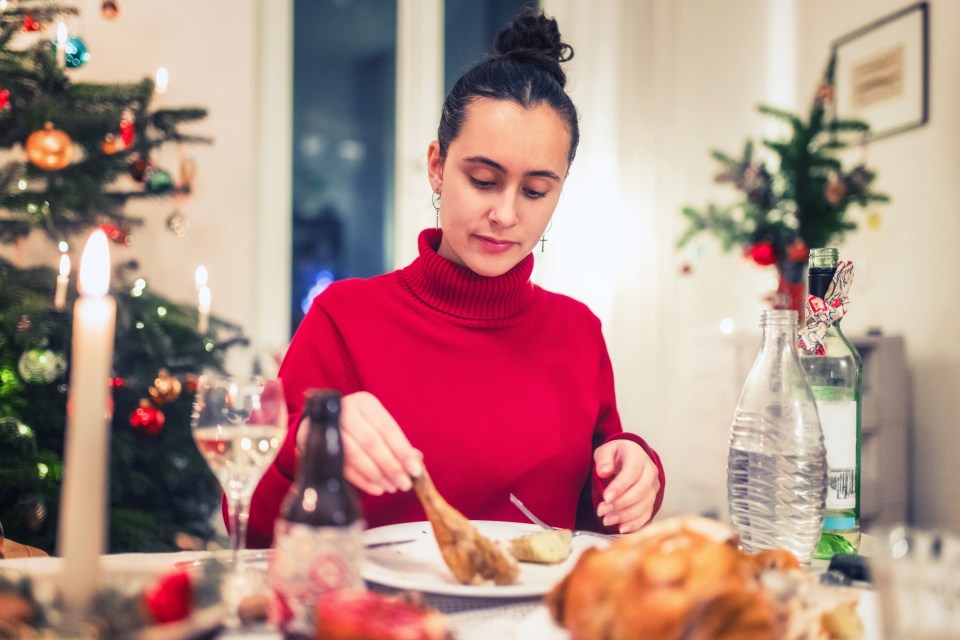 Young woman enjoying a Christmas dinner.