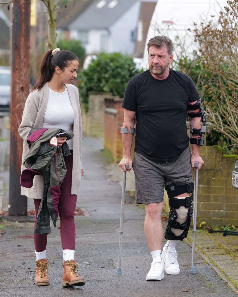 Nick Knowles on crutches after knee surgery.