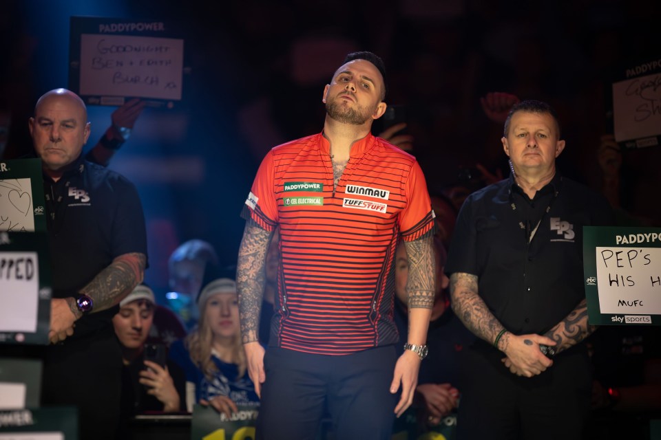 Joe Cullen walking on stage before a darts match.