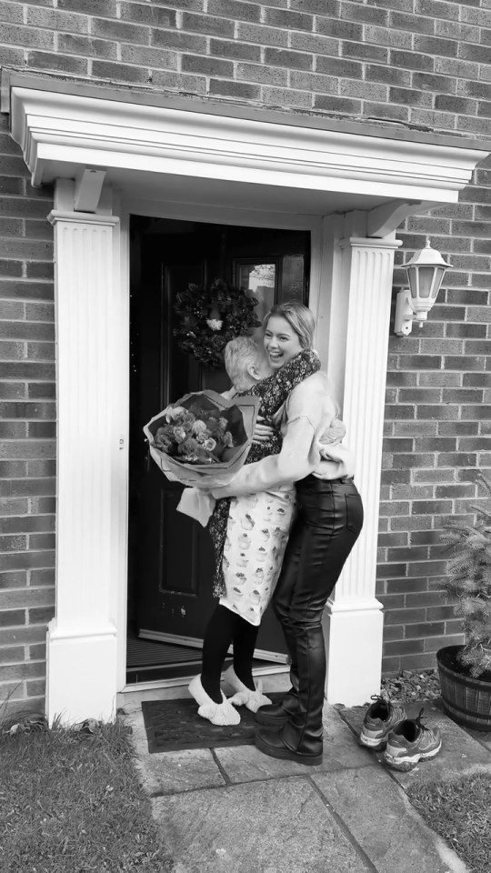 A woman surprises her former teacher with flowers after 15 years apart.