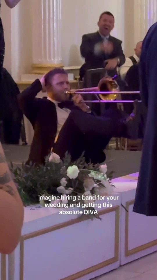 Trombone player performing animatedly at a wedding.