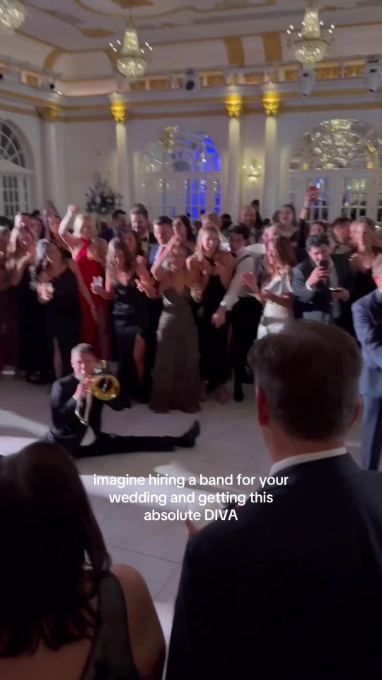 Trombone player performing a dramatic dance at a wedding.