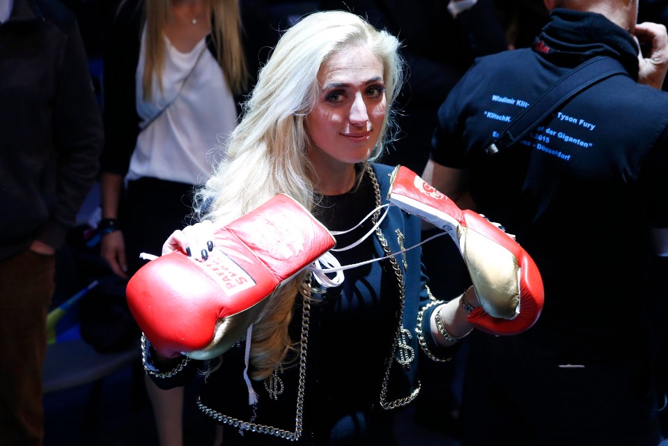 Paris Fury holding boxing gloves ringside at the Klitschko vs. Fury boxing match.