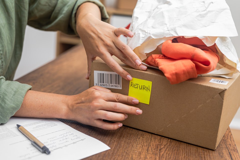 Woman affixing barcode to return package.