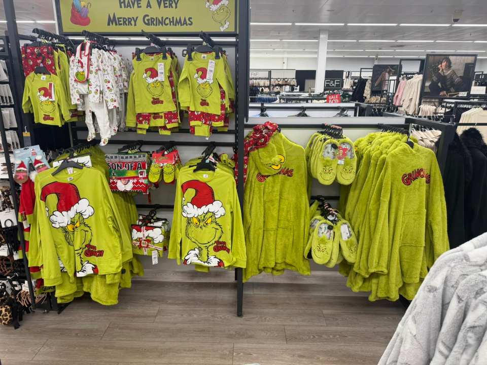 Grinch-themed pajamas and slippers displayed in a store.