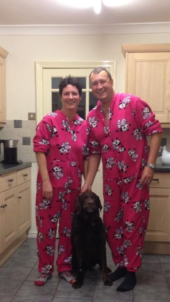 Wayne Mardle, his wife Donna, and their dog in matching pink cow pajamas.