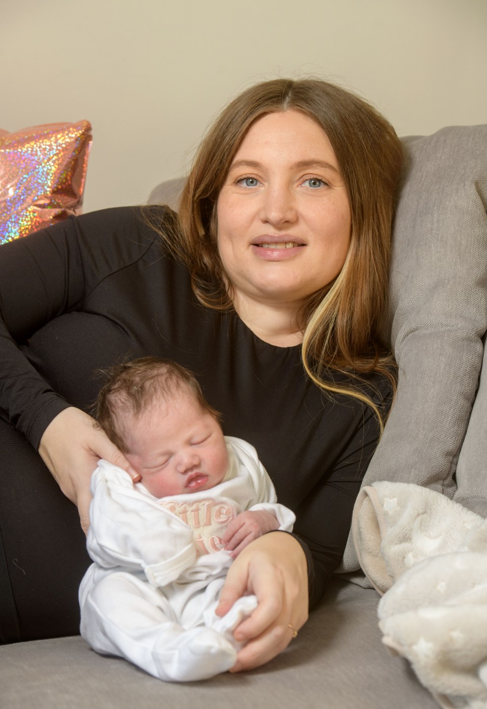 A mother holding her newborn baby.