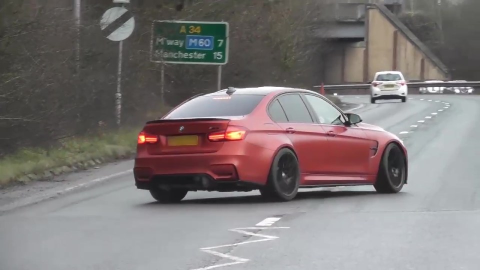 A red BMW was filmed crossing over into the right-hand lane