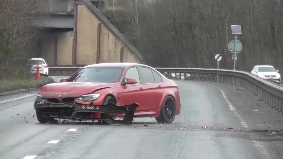 After crashing into the barrier, it span back into the road with shrapnel hanging off