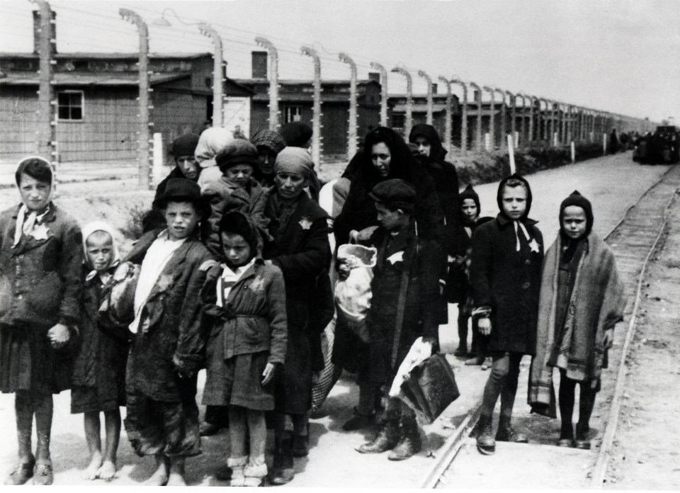 Hungarian Jews arriving at Auschwitz-Birkenau, wearing yellow stars.