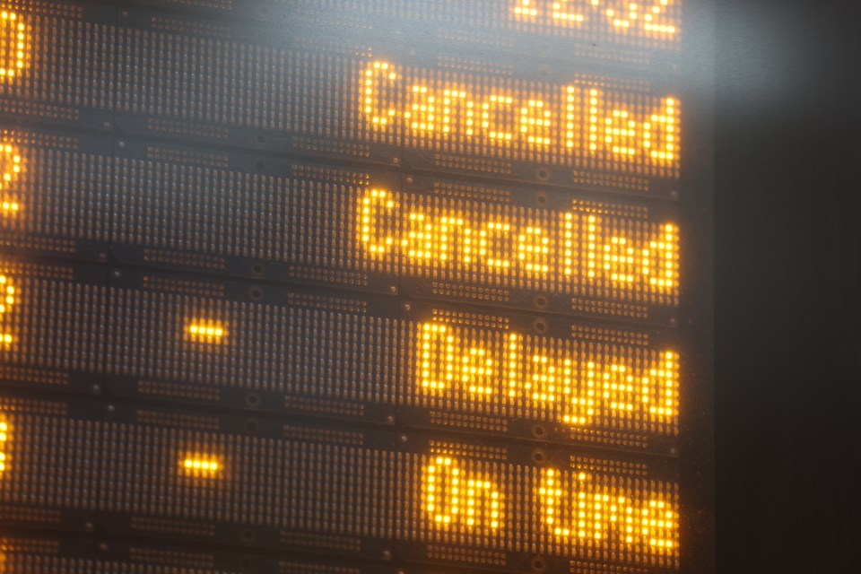 Train station departures board showing numerous cancelled and delayed trains.