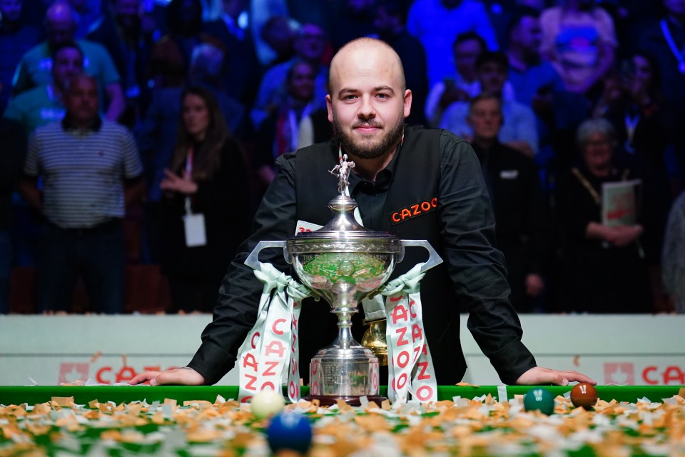 Luca Brecel with snooker championship trophy.