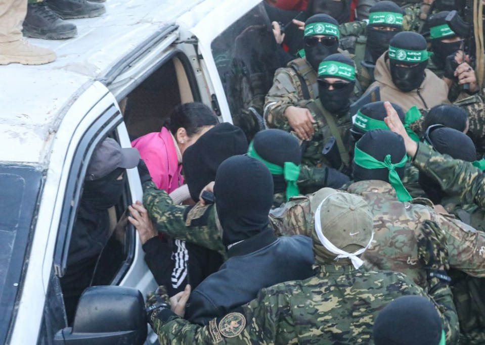 GAZA CITY, GAZA - JANUARY 19: Al-Qassam Brigades hands over 3 Israeli hostages to Red Cross at al-Saraya as part of 1st phase of ceasefire and prisoner swap deal between Israel and Hamas, in Gaza City, Gaza on January 19, 2025. (Photo by Dawoud Abo Alkas/Anadolu via Getty Images)