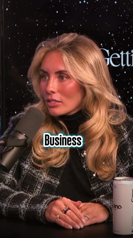 Woman speaking into a microphone, the word "Business" superimposed on the image.