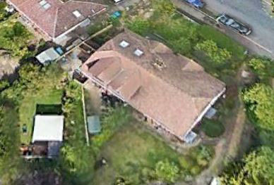 Aerial view of two properties with gardens and a newly installed fence.