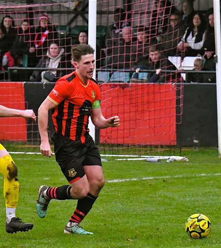 Two soccer players vying for the ball.