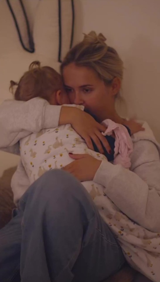 Molly-Mae hugging her baby while crying.