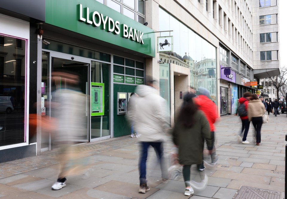 People walking past a Lloyds Bank branch in London.