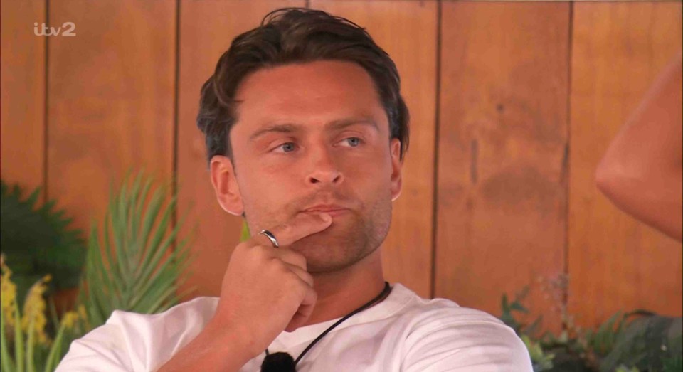 Casey O'Gorman from Love Island All Stars thoughtfully touches his chin.