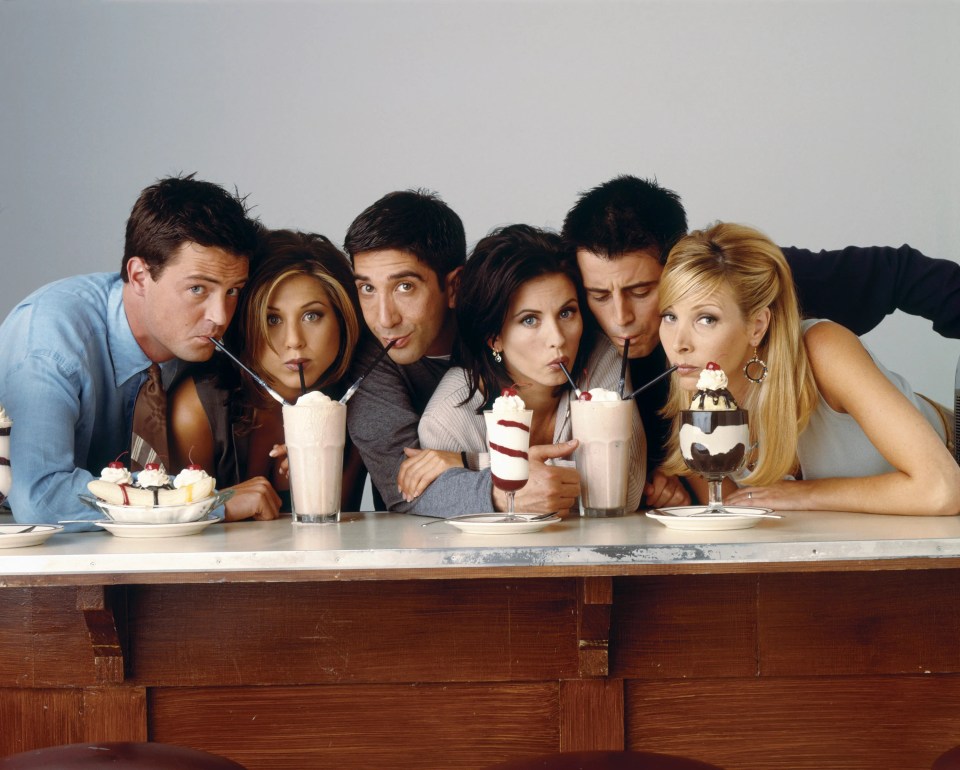 a group of people drinking milkshakes with straws