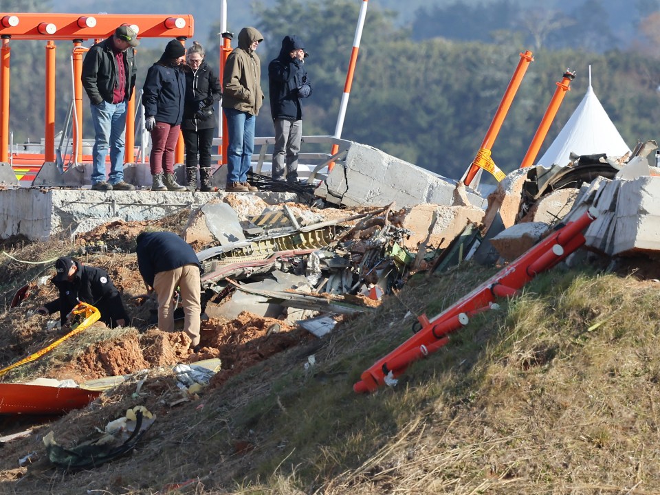 Investigators pick through the rubble of the plane