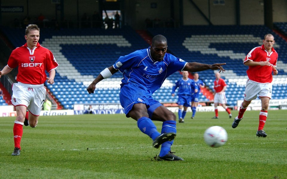 Soccer player kicking the ball during a game.