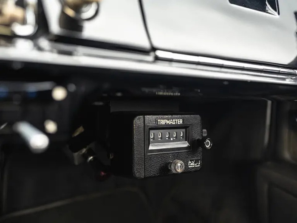 Close-up of a Tripmaster odometer in a classic car.