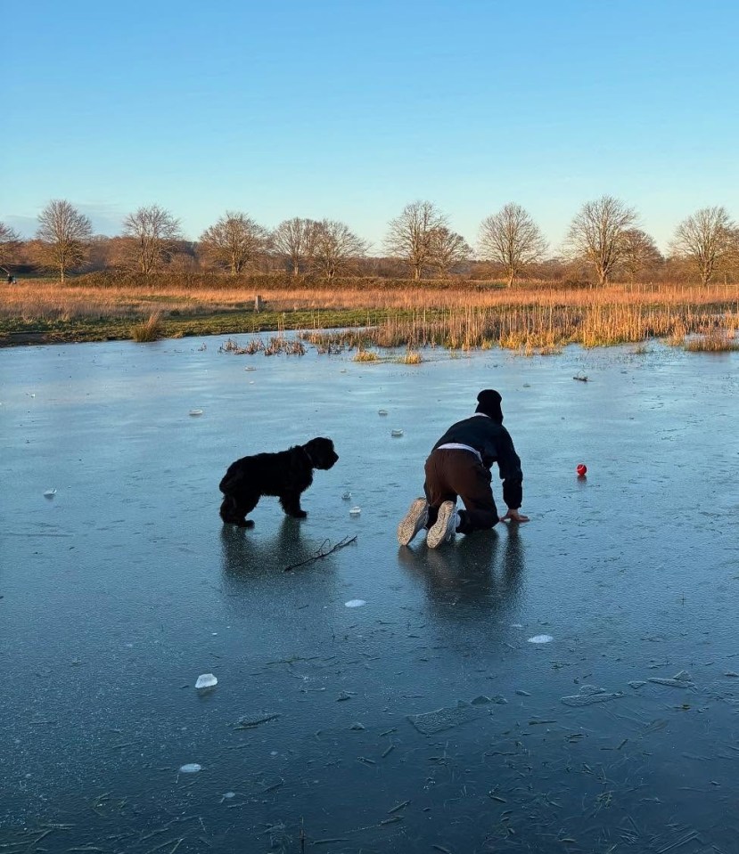 Family playing on a frozen lake with their dog.