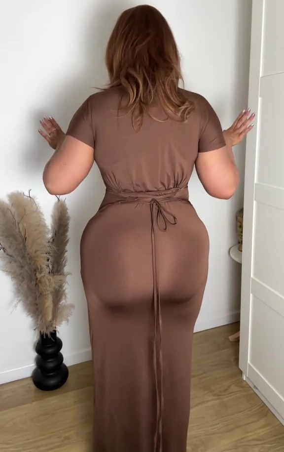 Woman in a brown maxi dress with a built-in corset.