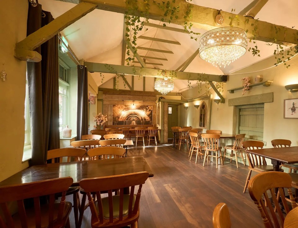 Interior photo of a pub with wooden tables and chairs.