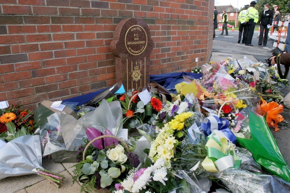 Memorial to murdered police officer PC Ian Broadhurst, with flowers and wreaths.