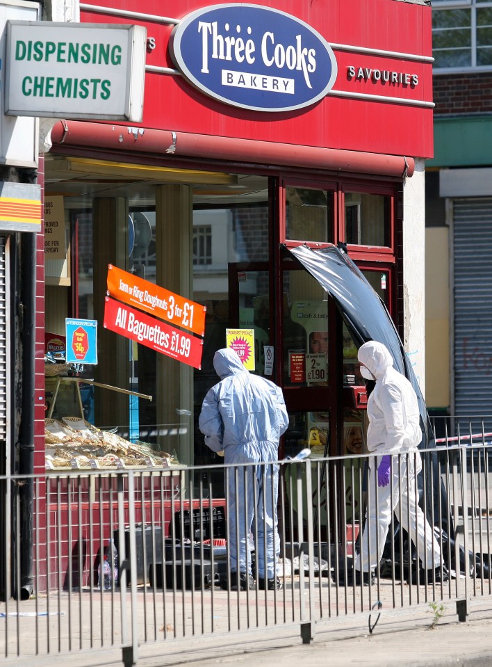 Forensic officers at a crime scene outside a bakery.