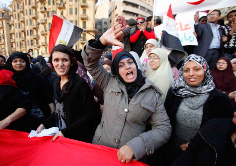 Protestors in Tahrir Square, Cairo, giving the thumbs down.