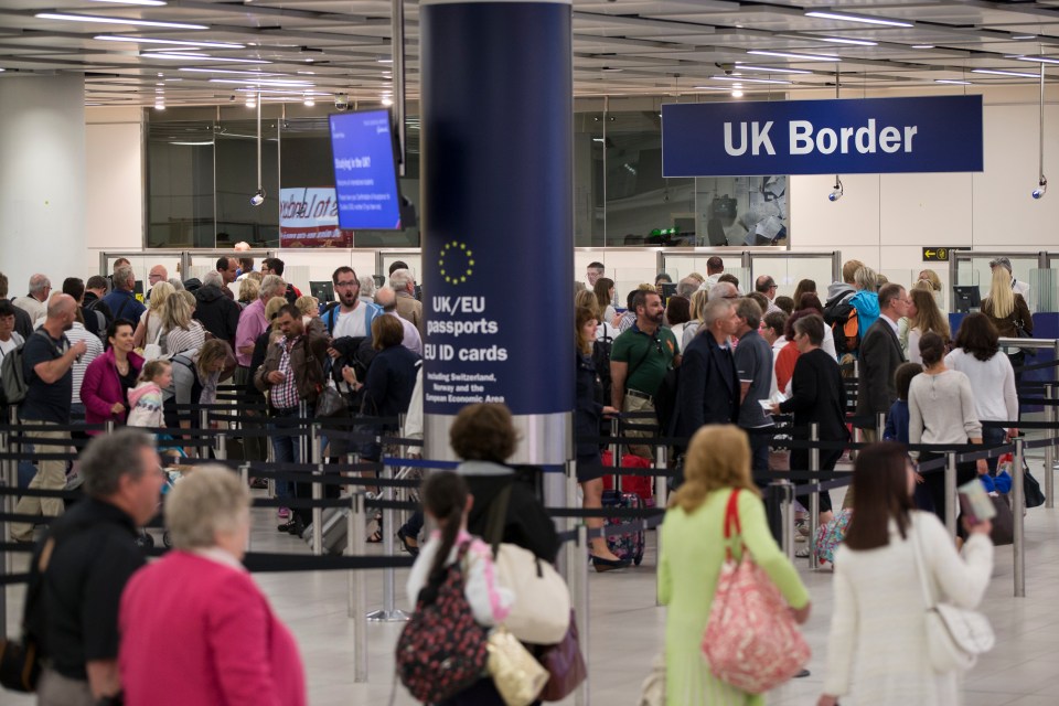 Passengers waiting in line at UK border control.