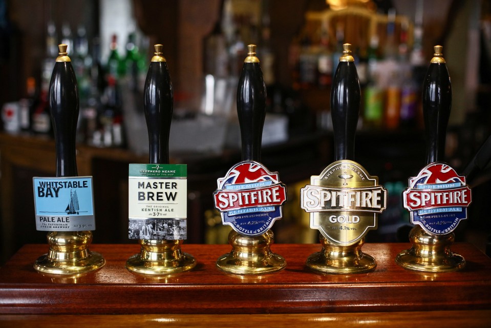 Beer tap handles with various ale labels.