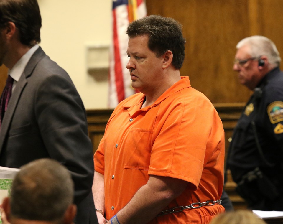 Todd Kohlhepp in court, wearing an orange jumpsuit and handcuffs.