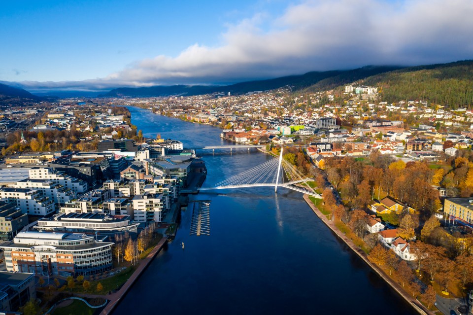 Aerial view of Drammen, Norway, featuring the Ypsilon Bridge over the Drammenselva River.